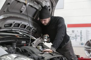 Mechanic Inspecting Car